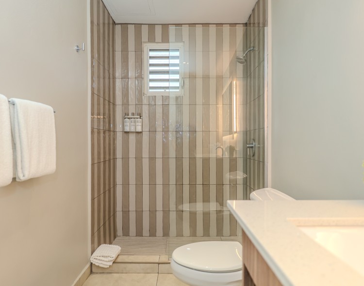 a bathroom with a glass shower and a sink