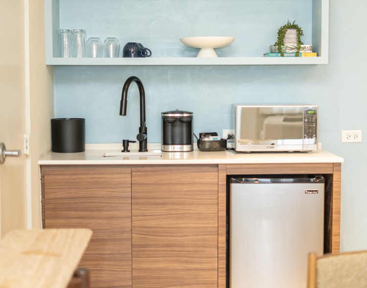 a kitchen with a small refrigerator and a sink