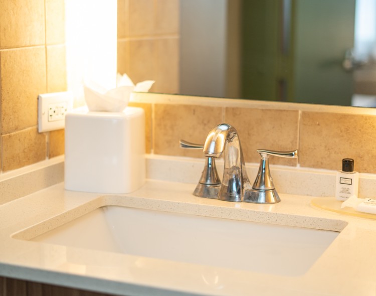 a sink with a soap and a tissue box