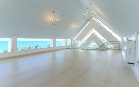 a large room with a large window and a view of the ocean