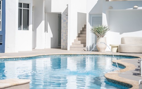 a swimming pool in a white building