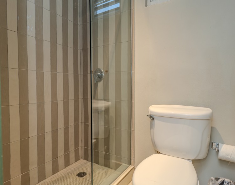 a bathroom with a glass shower door