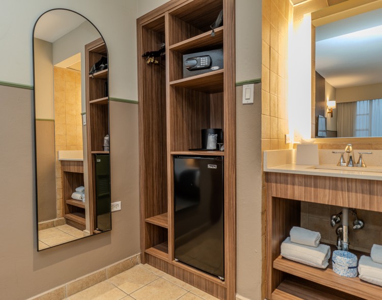 a bathroom with a mirror and a refrigerator