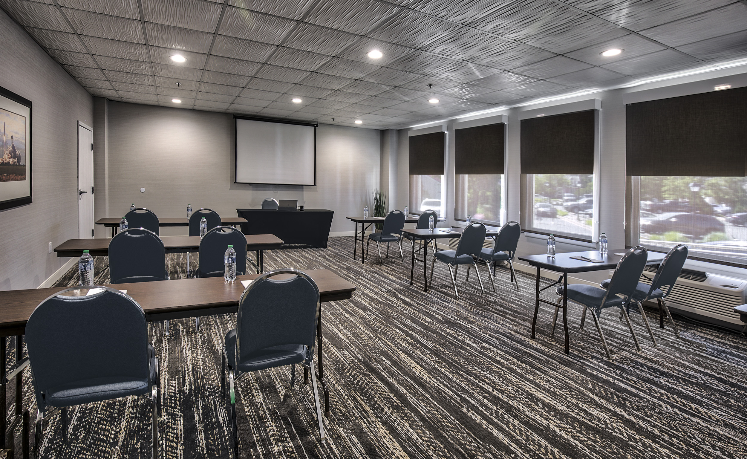 meetings room with table set up and a video beam