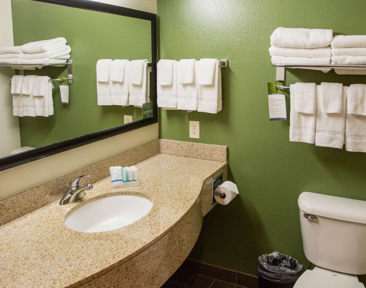 Bathroom with long sink area and plenty of towels