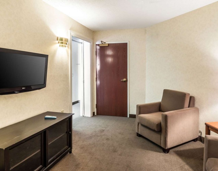 brown chair with tv above tv stand