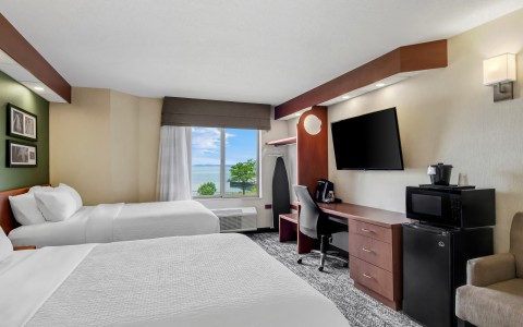 a room with two beds and a tv