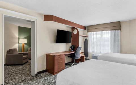 a room with two beds and a tv