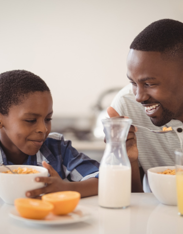 a man and boy eating cereal