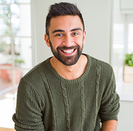 a man smiling at the camera