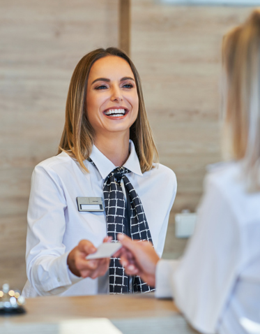 a woman handing a card to a woman