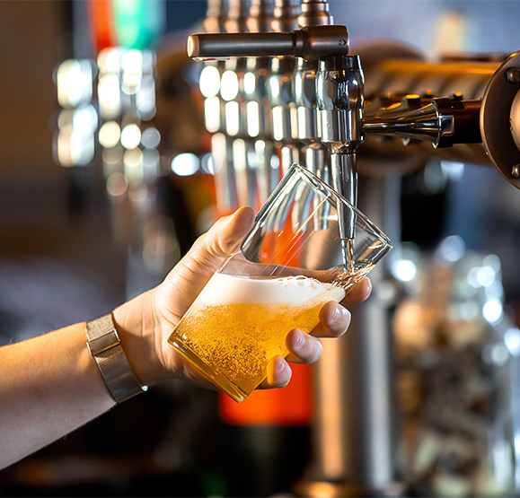 a hand holding a glass of beer
