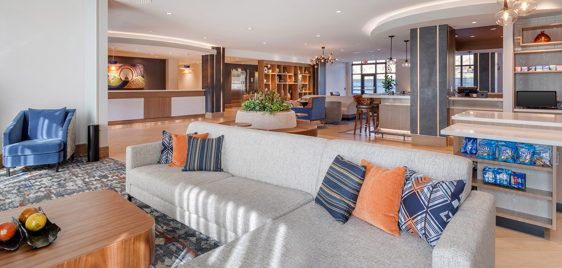 a large living room with a couch and a table