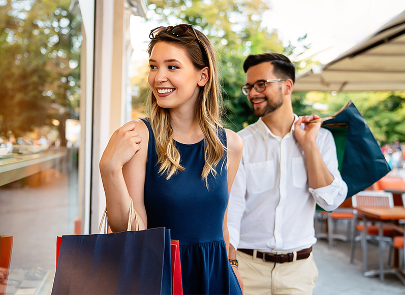 a man and woman holding shopping bags