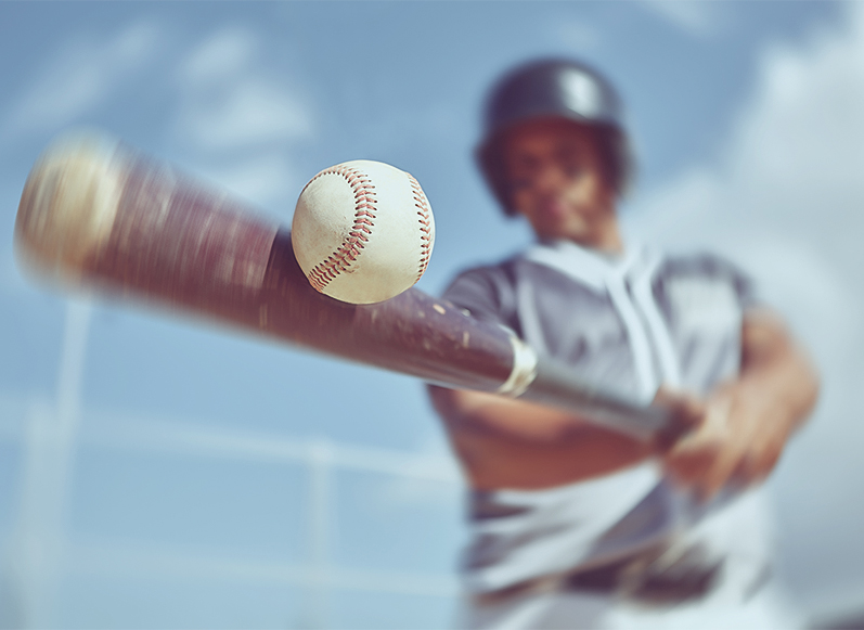 a baseball player hitting a ball with a bat