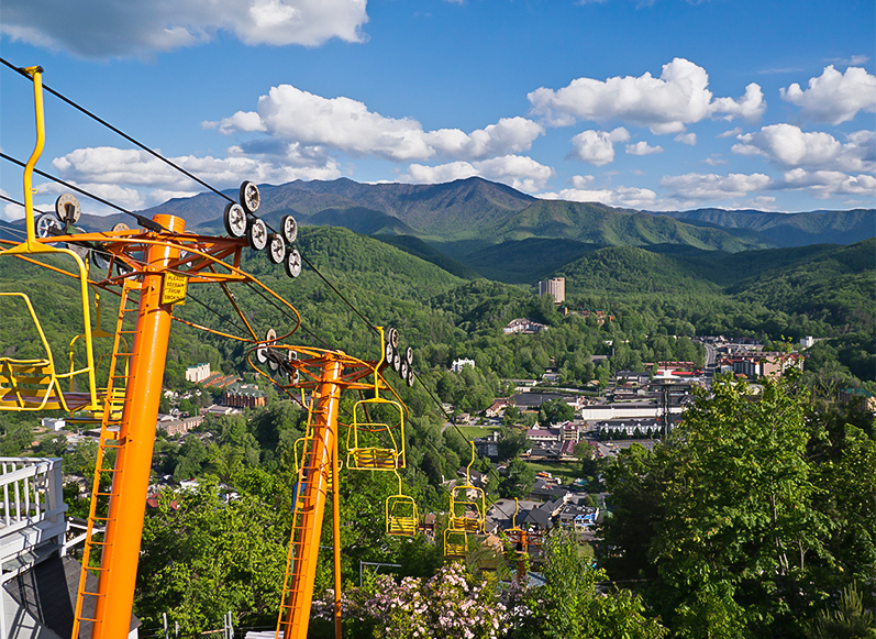 a cable car with a city in the background