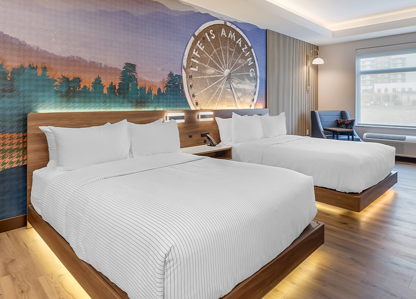 a room with two beds and a picture on the wall