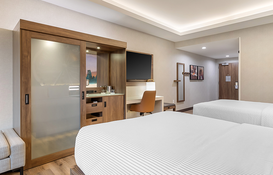 a room with two beds and a tv