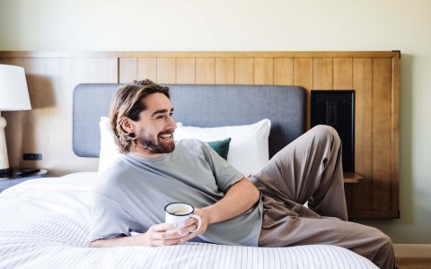 a man holding a cup in his hand