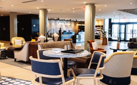 a table with chairs in a room with columns