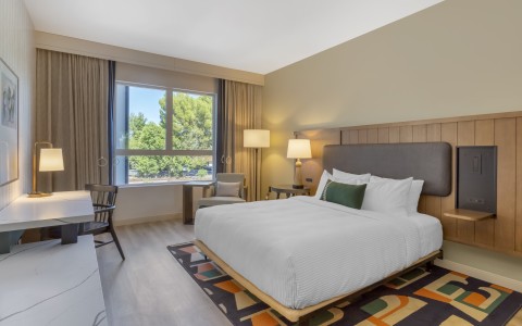 a room with a bed and a table and chairs