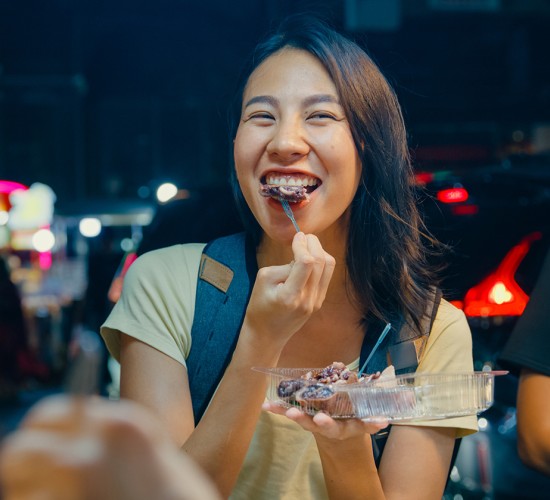 a woman eating a dessert