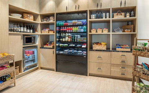 a refrigerator with drinks and beverages in a room