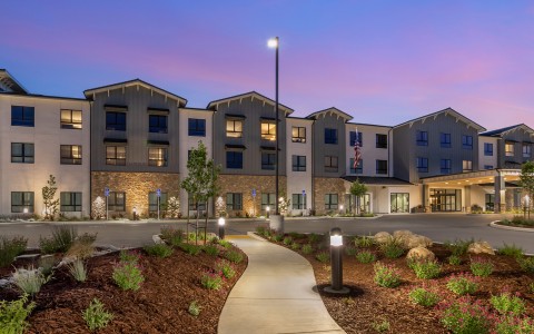 a building with a walkway and a street light
