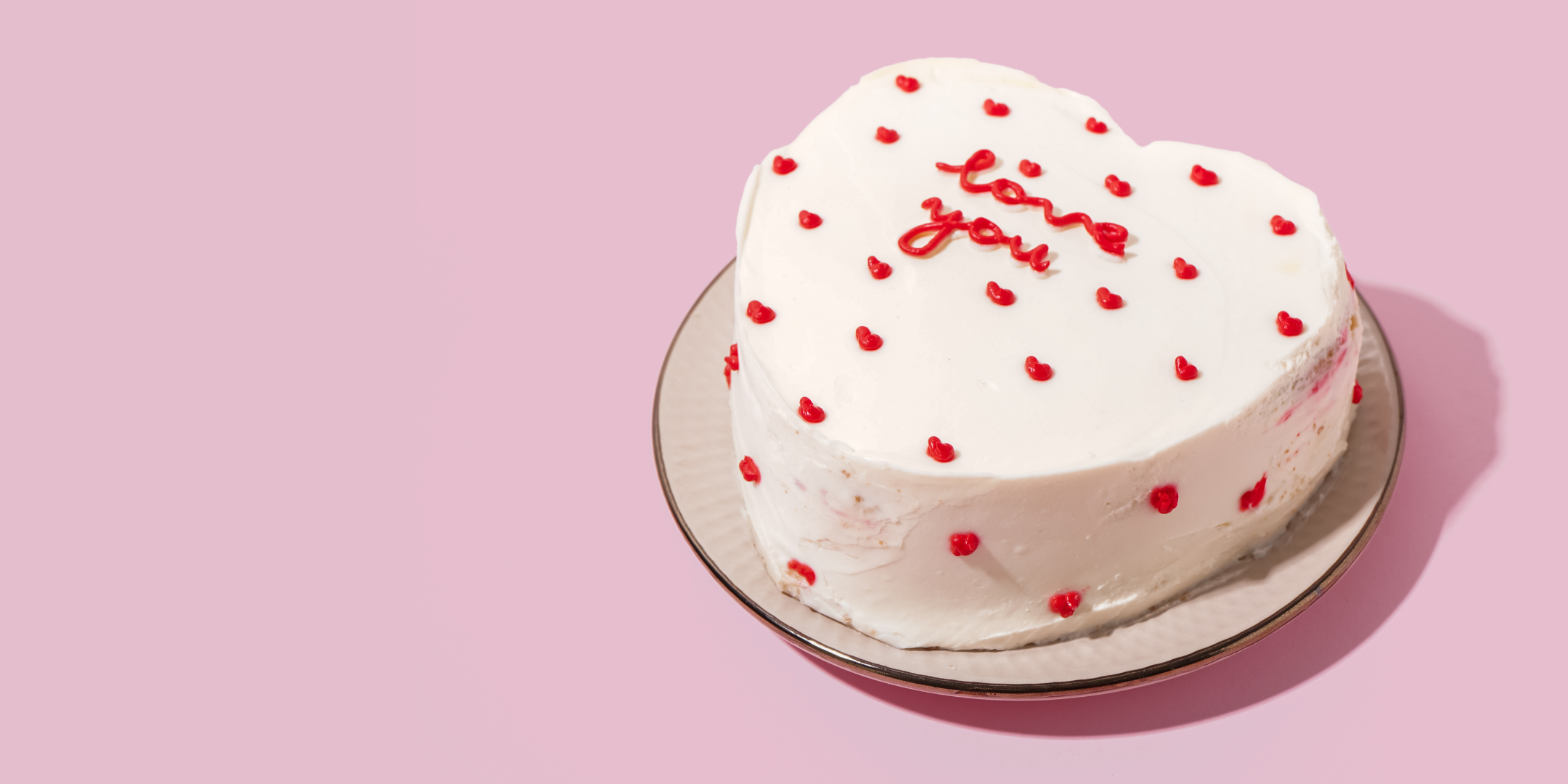 a white cake with red sprinkles on it