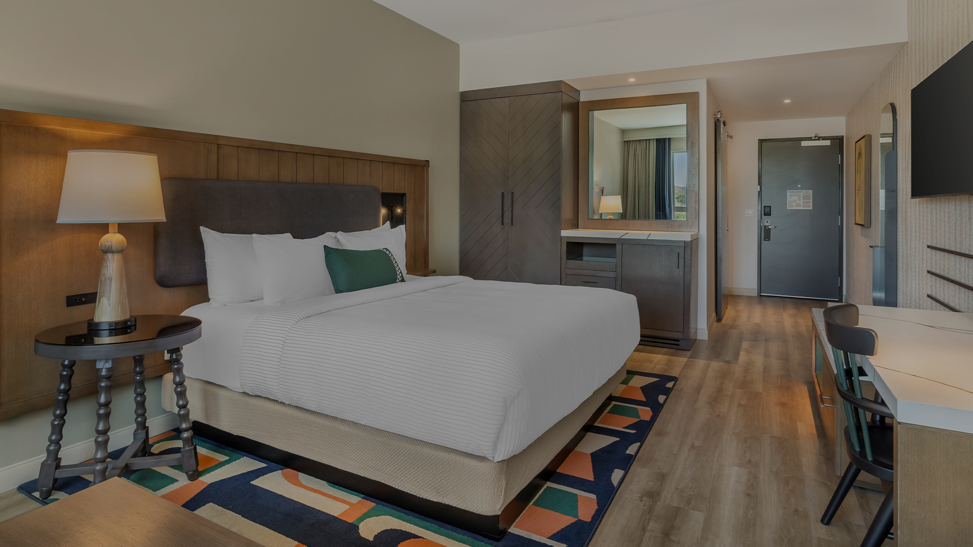 a room with a bed and a mirror