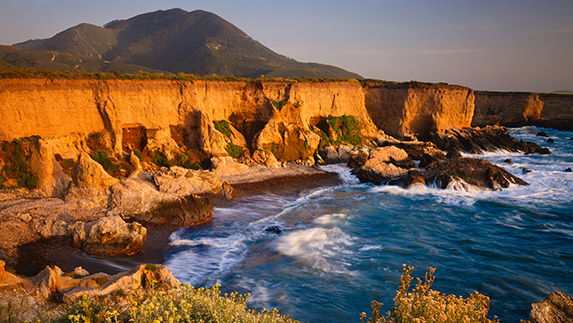 a rocky beach with a body of water