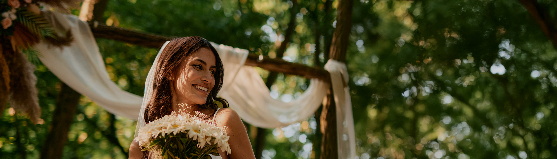 a woman smiling with a bouquet of flowers