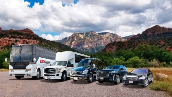 a group of vehicles parked in front of mountains