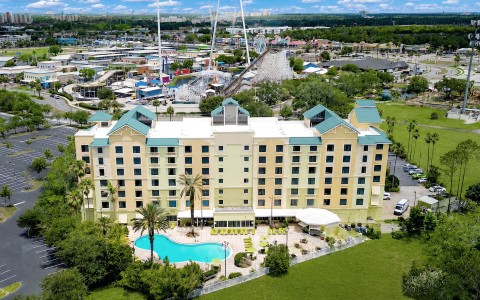 a building with a pool and trees