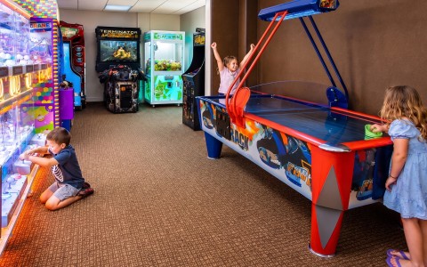 a boy and girl playing arcade games