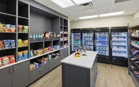 a room with shelves of snacks and drinks
