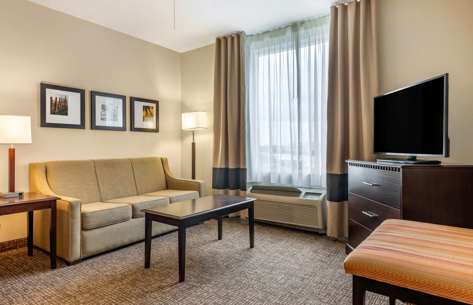 living room of suite with dresser and tv