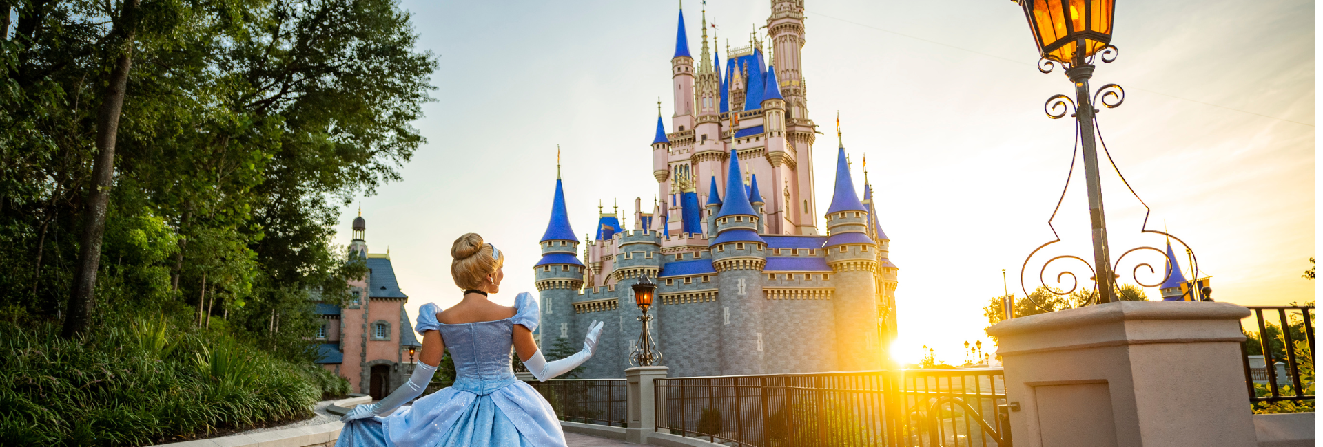 a woman in a blue dress and gloves standing in front of a castle