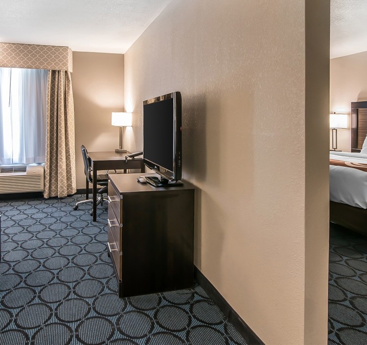 a room with a television and a desk