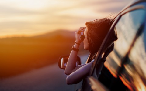 a woman looking out of a car window