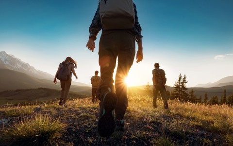 a group of people hiking on a hill