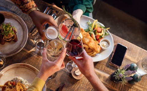 a group of people holding glasses of wine