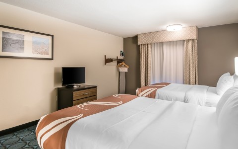 a room with two beds and a tv