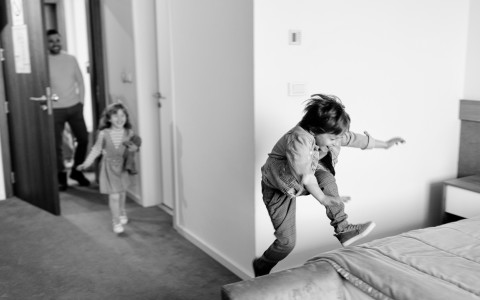 a group of children jumping on a couch