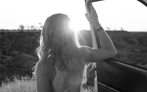 a woman looking out of a car window