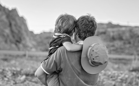 a man carrying a child