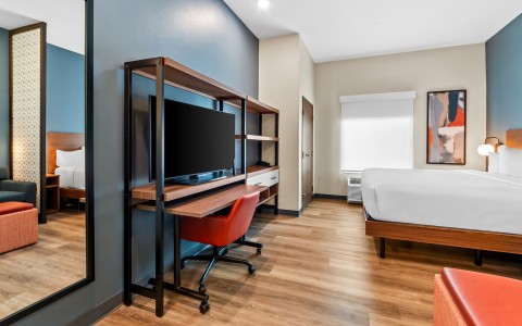 a room with a desk and a tv