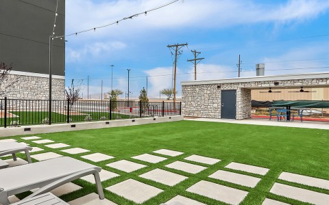 a lawn with chairs and a building