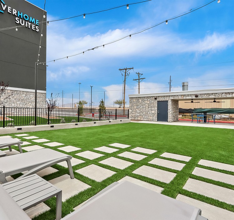 a lawn with chairs and a building