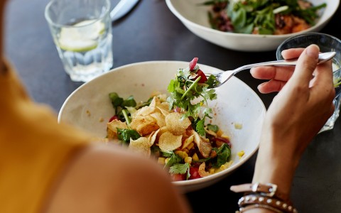 a person eating a salad